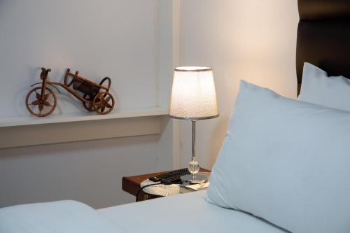 a bedroom with a bed and a table with a lamp at The Affectionate One in Louis Trichardt