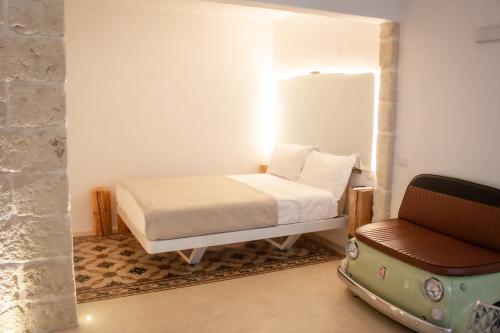 a bedroom with a bed and a chair at G home in Fasano