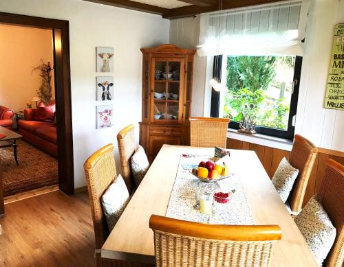 a dining room with a table with a bowl of fruit on it at Haus Westfeld in Schmallenberg