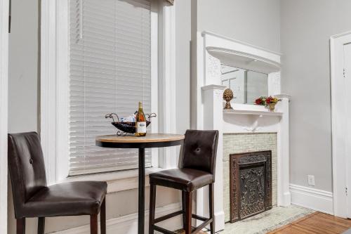 a table and two chairs in a room with a window at G1 central location museums FREE PARKING in Richmond