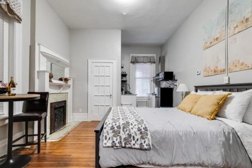 a bedroom with a bed and a table and a fireplace at G1 central location museums FREE PARKING in Richmond