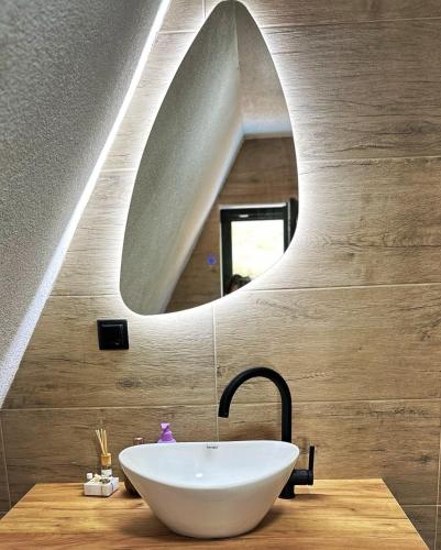a bathroom with a white sink and a mirror at Vila Edi Tuzla in Tuzla