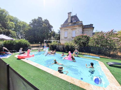 un groupe de personnes jouant dans une piscine dans l'établissement Château Couffins, à Asques