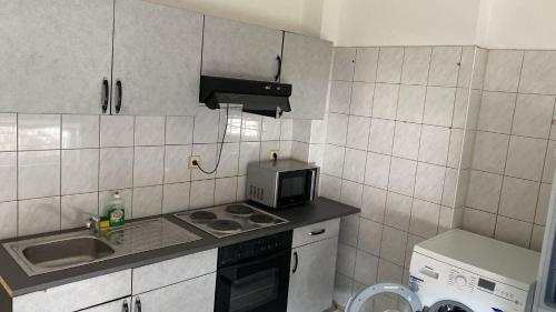 a small kitchen with a sink and a microwave at Villa Minden City in Minden