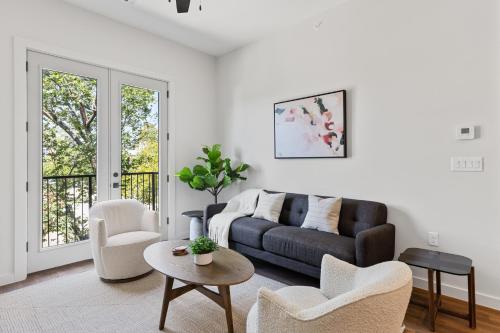 a living room with a couch and a table and chairs at The Corbin 1204 - Magnolia Moderns in Fort Worth
