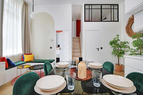 - un salon avec une table et des chaises vertes dans l'établissement Charming apartment 2BR- 4P - Rochechouart, à Paris