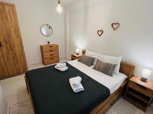 a bedroom with a bed with two towels on it at Ioannis Villa in Nea Fokea