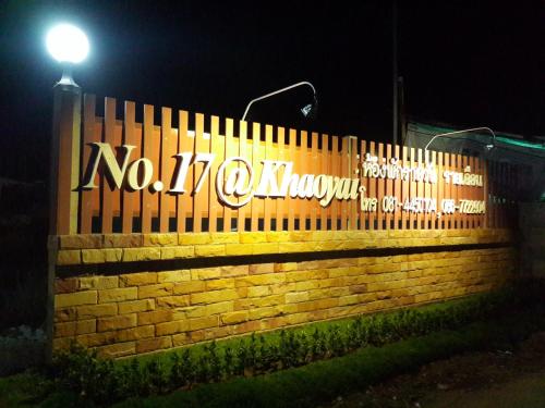 a sign on a brick wall with a street light at No.17 @ Khaoyai in Mu Si