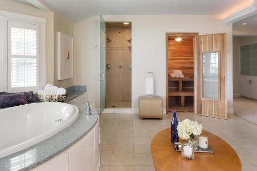 a large bathroom with a tub and a sink at Chatham Bars Inn in Chatham