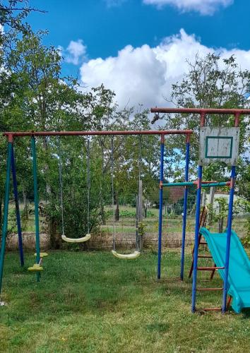 an empty playground with swings in a park at Guernazelles in Le Controis En Sologne
