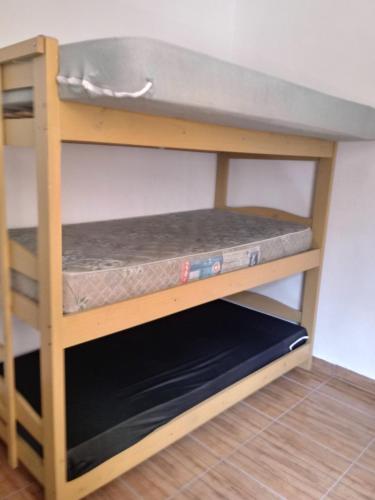 a bunk bed with a mattress on the bottom shelf at APMartinsjreige in São Vicente