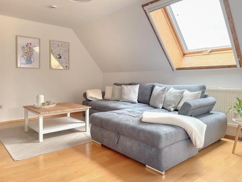 a living room with a couch and a window at Ferienwohnung Jack-Inn in Oberkirch