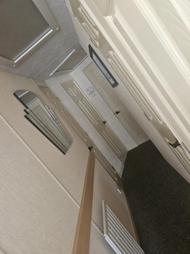 a room with white cabinets and a ceiling at the chase in Ingoldmells