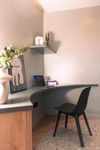 a desk with a chair and a laptop on it at Space Row Design Living in Heraklio Town