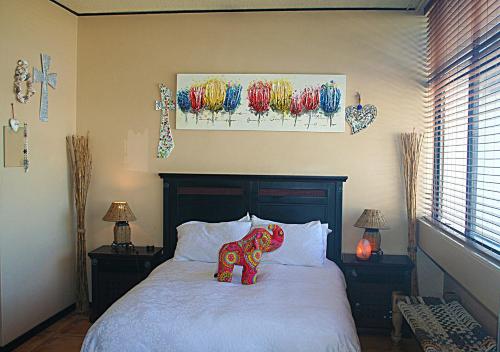 a bedroom with a bed with an elephant on it at U PRIVATE STUDIO apartment in Gardens Centre in Cape Town