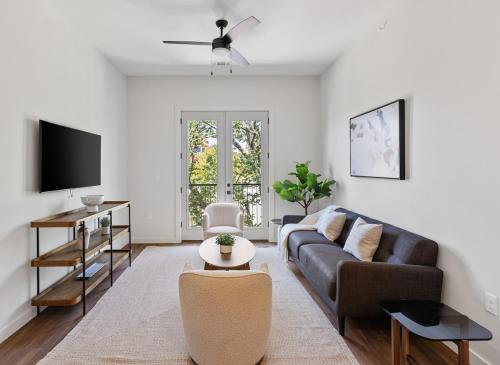 a living room with a couch and a tv at The Corbin 1307 - The Princeton in Fort Worth