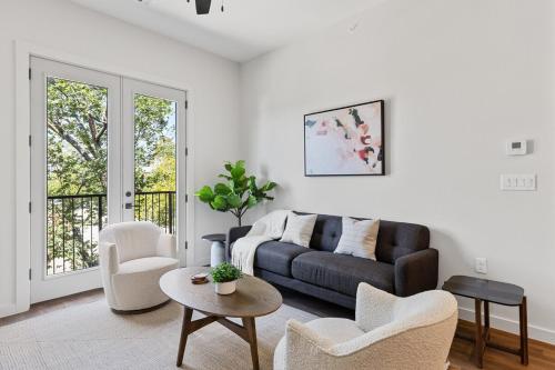 a living room with a couch and a table and chairs at The Corbin 1307 - The Princeton in Fort Worth