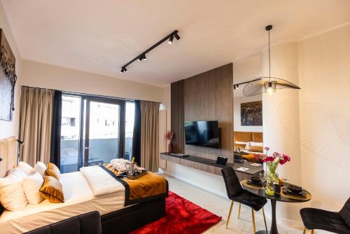a hotel room with a bed and a dining room at Kaleo apartments - Hanza Tower in Szczecin