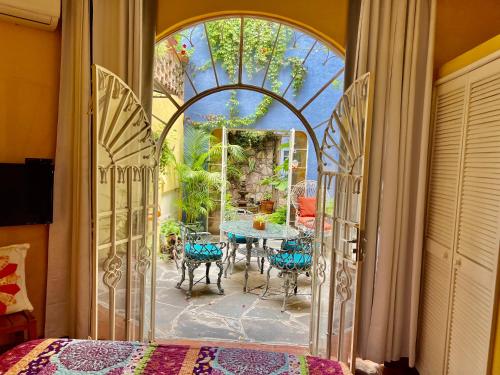 an open door to a patio with a table and chairs at Boutique Hotel Casa Camellia in San Miguel de Allende