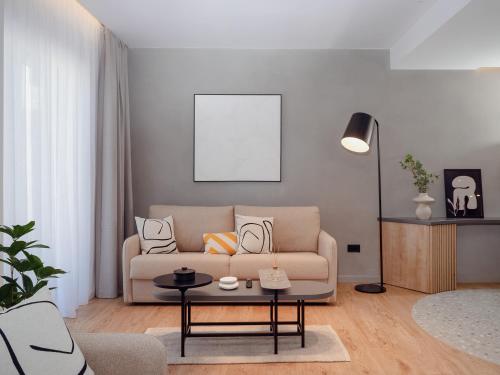 a living room with a couch and a table at Space Row Design Living in Heraklio Town