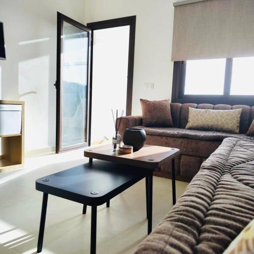 a living room with a couch and a coffee table at Colina Smir Resort Marina Smir, Tamuda Bay Kabila Beach, M'diq in Sania Torres
