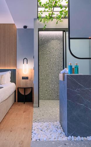 a bedroom with a bed and a glass shower at Space Row Design Living in Heraklio Town