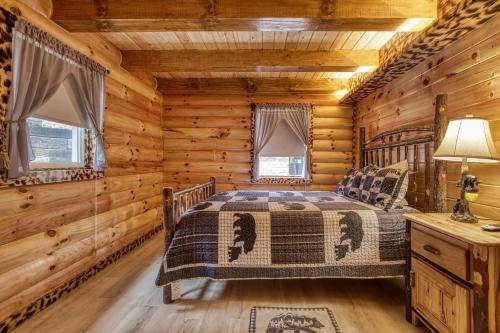 a bedroom with a bed in a log cabin at A Playful Bears Cabin #312 in Newport