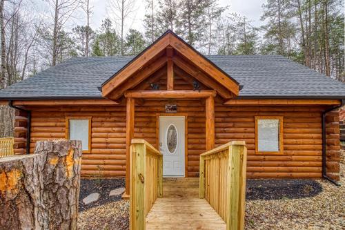 a log cabin with a white door and a fence at A Playful Bears Cabin #312 in Newport