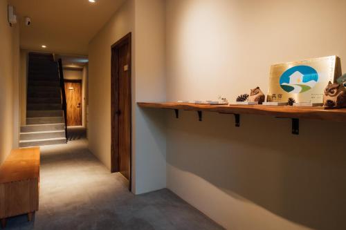 a hallway with a wooden shelf on the wall at Sweetfun in Ruifang