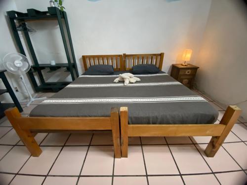a bedroom with two beds with a stuffed animal laying on it at Hostal Luz de Luna Nuyoo in Oaxaca City