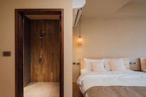 a bedroom with a bed and a shower at Sweetfun in Ruifang