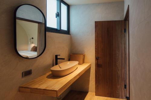 a bathroom with a sink and a mirror at Sweetfun in Ruifang