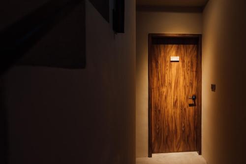 a hallway with a wooden door in a room at Sweetfun in Ruifang