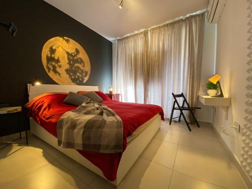a bedroom with a large bed and a window at New Stylish Design Apartment in St Julian's