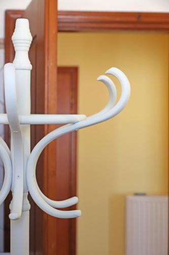 a white metal railing in front of a mirror at Virginia's guest house in Ermoupoli