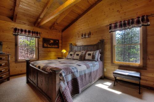 a bedroom with a bed in a log cabin at Almost Heaven #205 in Sevierville