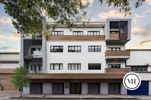 an image of a white building with aigil at Mariano Escobedo Apartments by VH in Mexico City