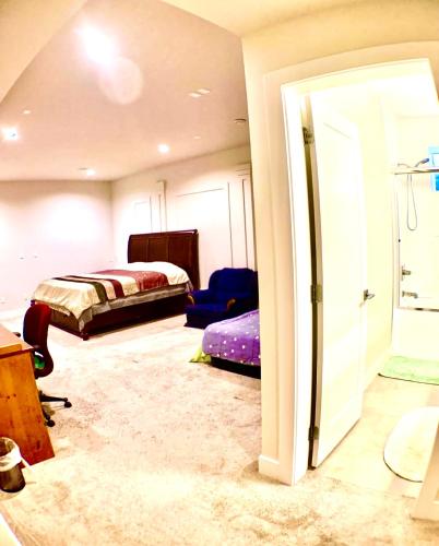 a bedroom with a bed and a door to a room at Deluxe House in Surrey
