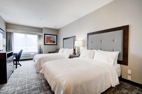 a hotel room with two beds and a television at Holiday Inn West Yellowstone by IHG in West Yellowstone