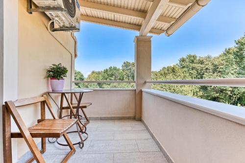 a balcony with a table and chairs on it at Serene Escape Suite in Corfu