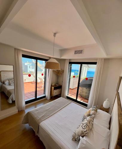 a bedroom with a bed with a view of the ocean at SEAVIEW Luxury PENTHOUSE in Casares