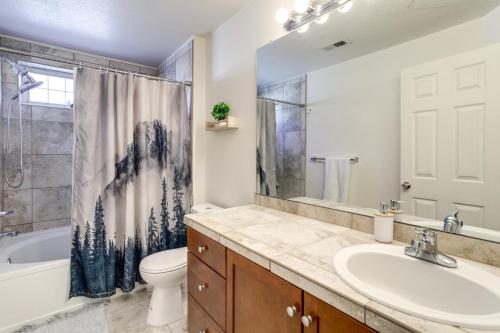 a bathroom with a sink and a tub and a toilet at 4 Mi to Airport Convenient Denver Condo in Aurora