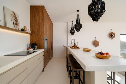 a kitchen with white counters and a counter top at Gr - Villa La Punta in Plaka