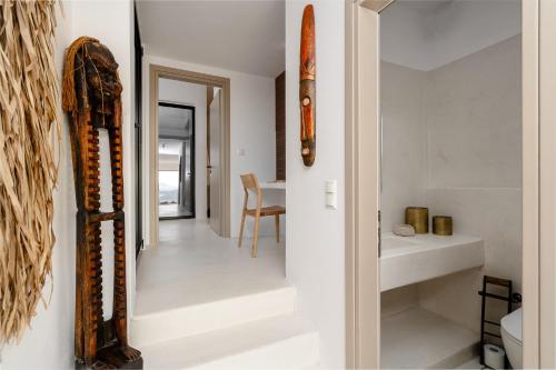 a hallway of a house with white walls and stairs at Gr - Villa La Punta in Plaka