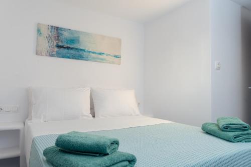 a bedroom with a bed with two towels on it at Allegro seasight appartment in Livadi Astypalaias