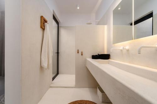 a white bathroom with two sinks and a mirror at Gr - Villa La Punta in Plaka