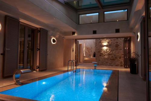 a swimming pool in the middle of a house at Manili Boutique Suites & Villas in Archanes