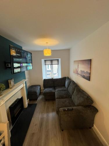 a living room with a couch and a fireplace at 6 Eyre Square Lane in Galway