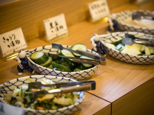 three bowls of food on a wooden table with signs at Hotel Yagi - Vacation STAY 25619v in Awara