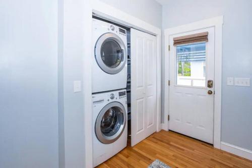 a white laundry room with a washer and dryer at The Southport Cottage! in Southport